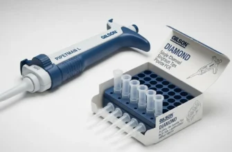 A Gilson PIPETMAN L adjustable volume pipette with a box of Diamond tips on a lab bench